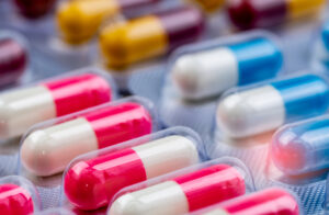 Selective focus on pink-white antibiotic capsule pills in bliste